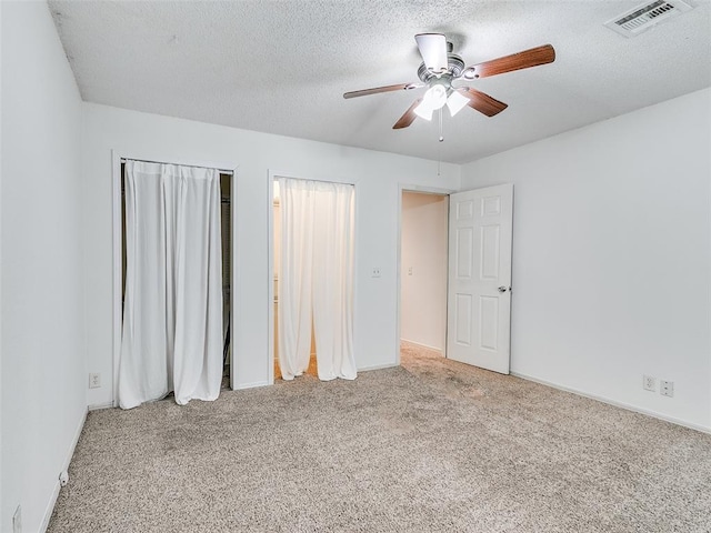 1040 Mabel C Fry Blvd, Yukon, OK 73099 - unfurnished bedroom with carpet flooring, a textured ceiling, and ceiling fan