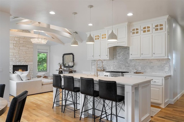 1517 Station St, Edmond, OK 73034 - kitchen featuring backsplash, light countertops, light wood-type flooring, white cabinets, and recessed lighting