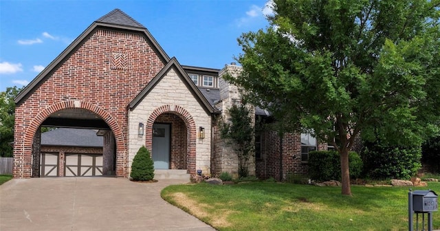 1517 Station St, Edmond, OK 73034 - view of front of house featuring stone siding, concrete driveway, brick siding, a front lawn, and an attached garage