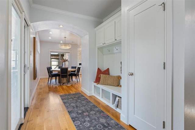 1517 Station St, Edmond, OK 73034 - mudroom featuring light wood-style flooring, arched walkways, and crown molding