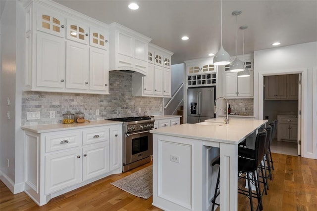 1517 Station St, Edmond, OK 73034 - kitchen with appliances with stainless steel finishes, tasteful backsplash, light wood finished floors, white cabinetry, and recessed lighting