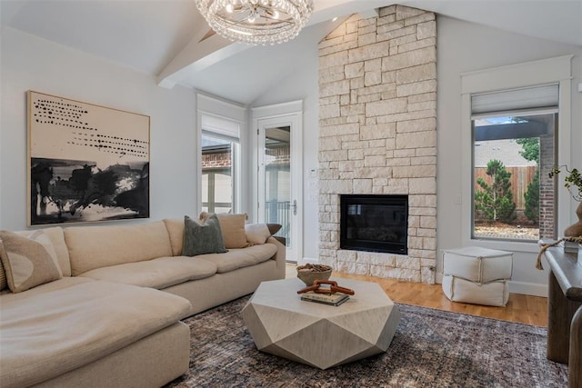 1517 Station St, Edmond, OK 73034 - living room featuring lofted ceiling, plenty of natural light, wood finished floors, a chandelier, and a fireplace