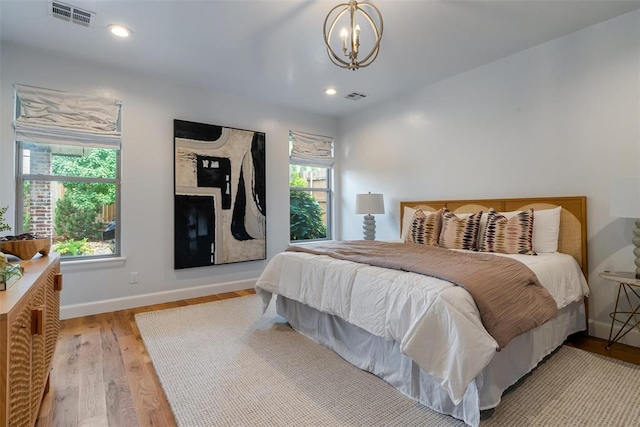 1517 Station St, Edmond, OK 73034 - bedroom featuring multiple windows, a chandelier, wood finished floors, and recessed lighting