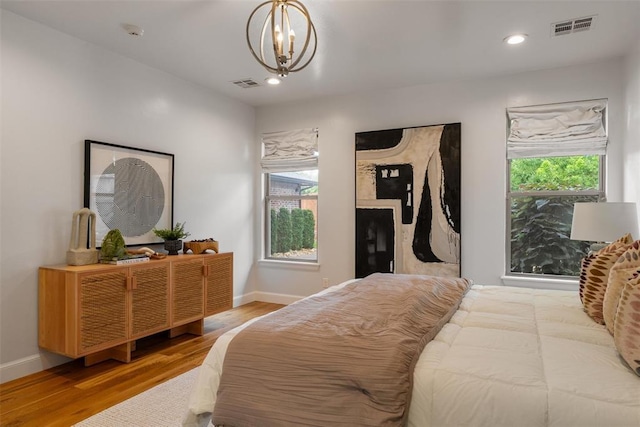 1517 Station St, Edmond, OK 73034 - bedroom with wood finished floors, a chandelier, and recessed lighting