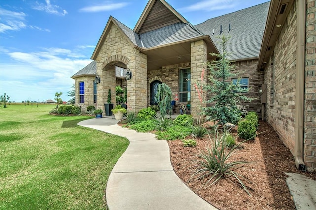 15936 SW 12th St, Yukon, OK 73099 - view of front facade with roof with shingles, a front lawn, and stone siding