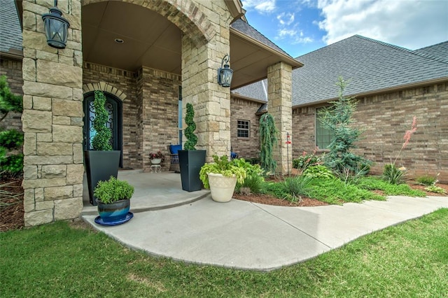 15936 SW 12th St, Yukon, OK 73099 - view of exterior entry featuring brick siding and roof with shingles