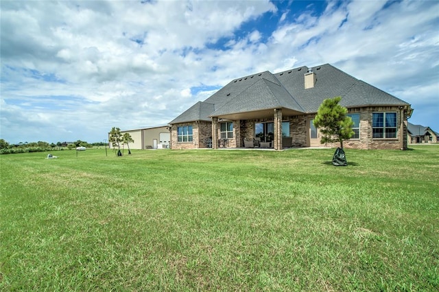 15936 SW 12th St, Yukon, OK 73099 - back of house featuring a yard, brick siding, and a shingled roof