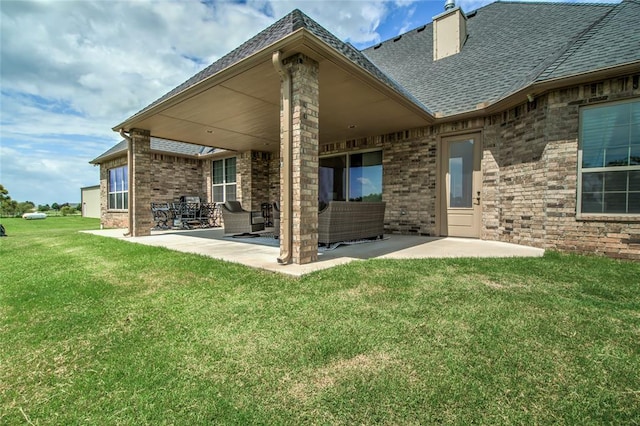 15936 SW 12th St, Yukon, OK 73099 - rear view of house featuring a patio area, a lawn, a shingled roof, brick siding, and an outdoor hangout area