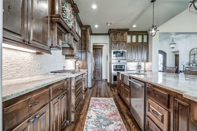 15936 SW 12th St, Yukon, OK 73099 - kitchen with appliances with stainless steel finishes, dark wood-style floors, decorative backsplash, light stone counters, and recessed lighting