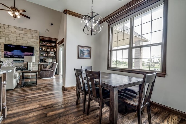 15936 SW 12th St, Yukon, OK 73099 - dining area featuring a chandelier, dark wood-style flooring, ceiling fan, high vaulted ceiling, and built in shelves