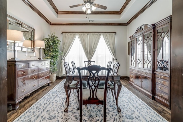 15936 SW 12th St, Yukon, OK 73099 - dining room with a raised ceiling, a ceiling fan, dark wood finished floors, and ornamental molding