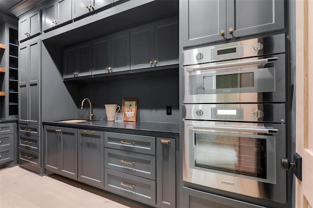 3005 Bee Hive Way, Jones, OK 73049 - kitchen with stainless steel double oven, dark countertops, and gray cabinetry