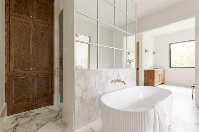 3005 Bee Hive Way, Jones, OK 73049 - full bathroom featuring marble tiled floors, a freestanding tub, vanity, a shower stall, and tile walls