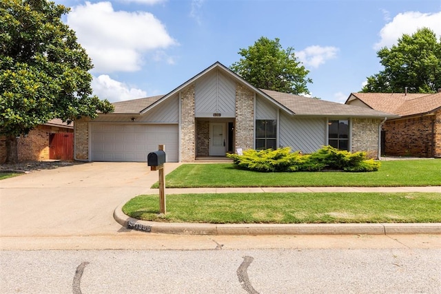1909 Magnolia Ln, Edmond, OK 73013 - mid-century modern home with a garage, brick siding, driveway, and a front lawn