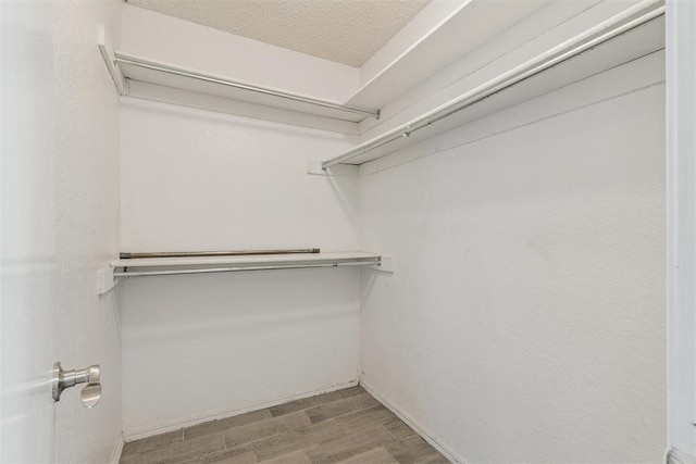 1909 Magnolia Ln, Edmond, OK 73013 - spacious closet featuring wood finished floors