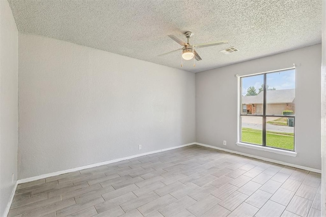 1909 Magnolia Ln, Edmond, OK 73013 - spare room with ceiling fan, a textured ceiling, and wood tiled floors
