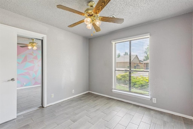 1909 Magnolia Ln, Edmond, OK 73013 - spare room featuring a ceiling fan, wood finished floors, and a textured ceiling