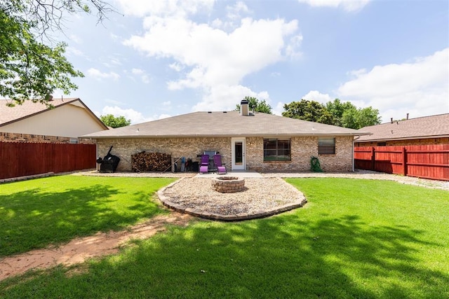 1909 Magnolia Ln, Edmond, OK 73013 - rear view of property featuring a fenced backyard, a fire pit, brick siding, and a chimney