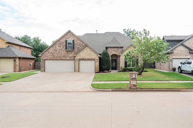 413 Branch Line Rd, Yukon, OK 73099 - view of front of property featuring driveway, a front lawn, and brick siding