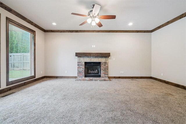 413 Branch Line Rd, Yukon, OK 73099 - unfurnished living room with carpet flooring, ceiling fan, a brick fireplace, recessed lighting, and crown molding