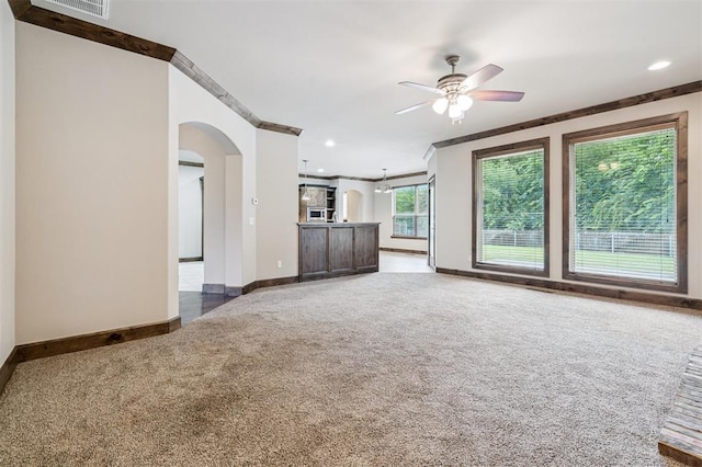 413 Branch Line Rd, Yukon, OK 73099 - unfurnished living room featuring carpet flooring, arched walkways, a ceiling fan, ornamental molding, and recessed lighting
