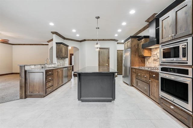413 Branch Line Rd, Yukon, OK 73099 - kitchen with appliances with stainless steel finishes, arched walkways, decorative backsplash, ornamental molding, and a center island