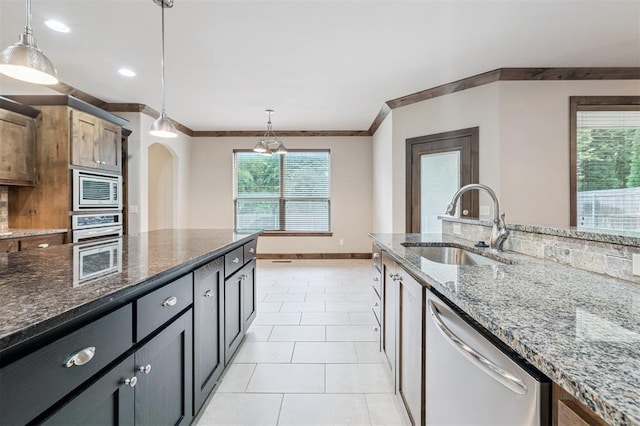 413 Branch Line Rd, Yukon, OK 73099 - kitchen with appliances with stainless steel finishes, arched walkways, hanging light fixtures, crown molding, and dark stone countertops