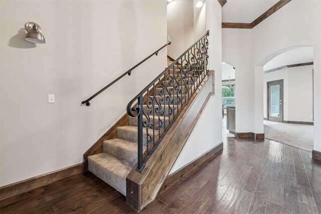 413 Branch Line Rd, Yukon, OK 73099 - stairs featuring arched walkways, a high ceiling, wood finished floors, and crown molding