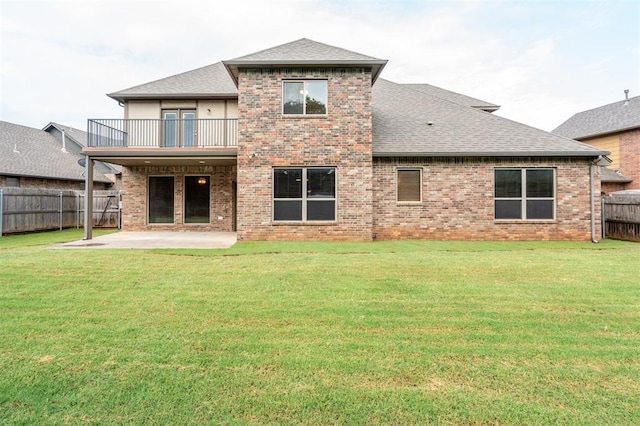 413 Branch Line Rd, Yukon, OK 73099 - rear view of house with a balcony, a patio, a fenced backyard, roof with shingles, and brick siding