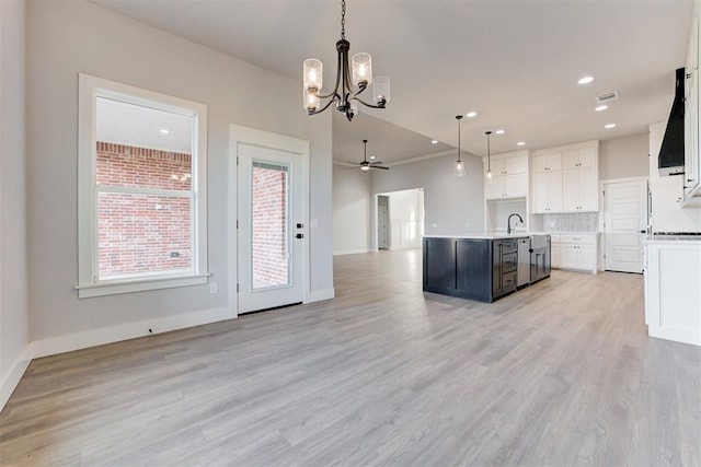 4337 Pinon Ln, Piedmont, OK 73078 - kitchen featuring open floor plan, a chandelier, an island with sink, range hood, and white cabinets