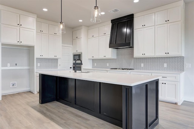 4337 Pinon Ln, Piedmont, OK 73078 - kitchen with light wood-style flooring, white cabinets, custom exhaust hood, and recessed lighting