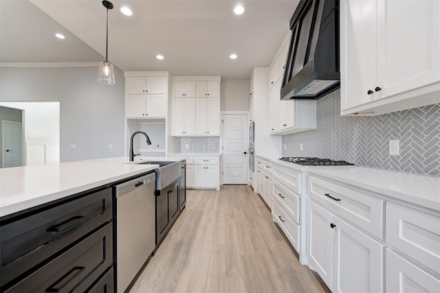 4337 Pinon Ln, Piedmont, OK 73078 - kitchen with appliances with stainless steel finishes, wall chimney exhaust hood, white cabinetry, backsplash, and crown molding