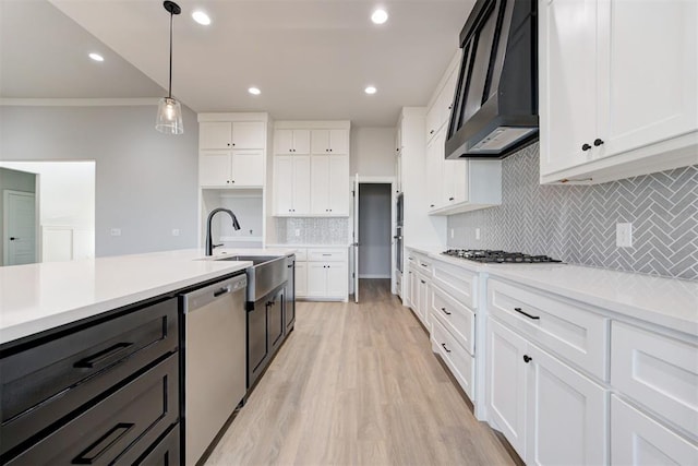 4337 Pinon Ln, Piedmont, OK 73078 - kitchen featuring appliances with stainless steel finishes, wall chimney range hood, white cabinets, ornamental molding, and light countertops