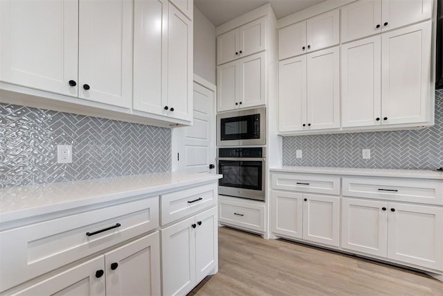4337 Pinon Ln, Piedmont, OK 73078 - kitchen with oven, built in microwave, light countertops, and white cabinetry