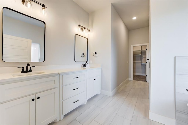 4337 Pinon Ln, Piedmont, OK 73078 - bathroom with double vanity, a walk in closet, and recessed lighting