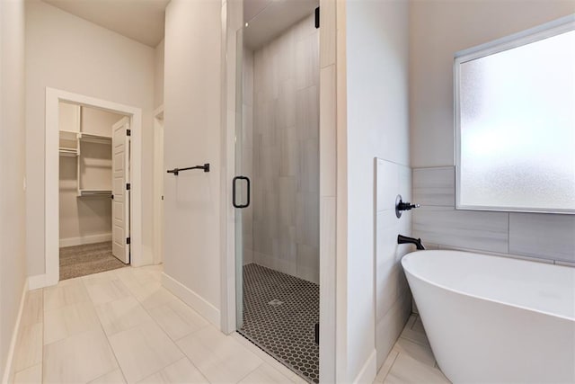 4337 Pinon Ln, Piedmont, OK 73078 - full bath featuring a stall shower, a spacious closet, and a freestanding tub