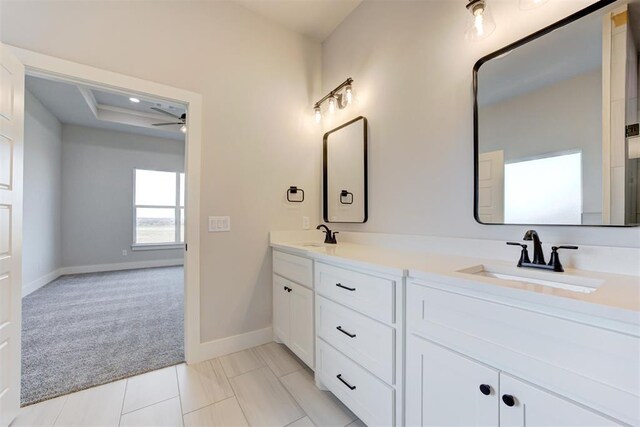 4337 Pinon Ln, Piedmont, OK 73078 - full bathroom with double vanity, ceiling fan, and a raised ceiling