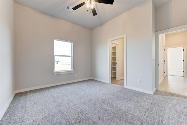 4337 Pinon Ln, Piedmont, OK 73078 - unfurnished bedroom with light colored carpet, a spacious closet, and ceiling fan