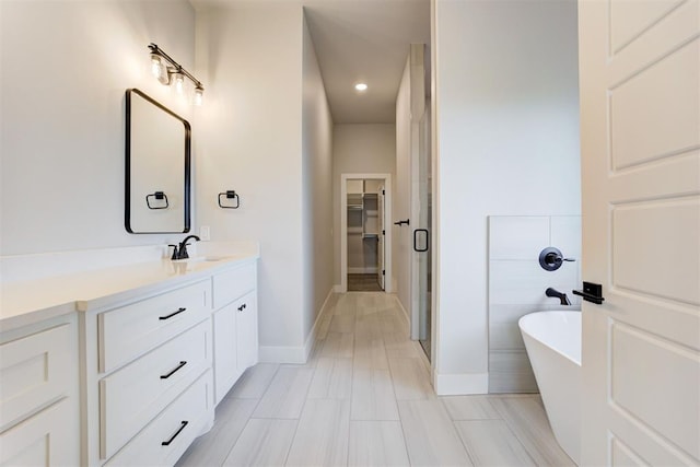 4337 Pinon Ln, Piedmont, OK 73078 - full bathroom with vanity, a freestanding tub, a spacious closet, and recessed lighting