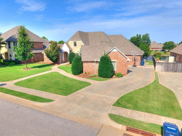 13705 Cascata Strada St, Oklahoma City, OK 73170 - view of front of property featuring brick siding, driveway, and a residential view