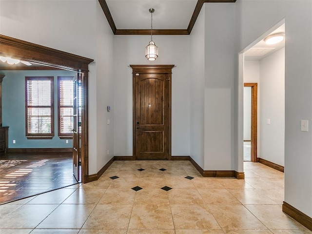 13705 Cascata Strada St, Oklahoma City, OK 73170 - entryway with light tile patterned flooring, crown molding, and a towering ceiling