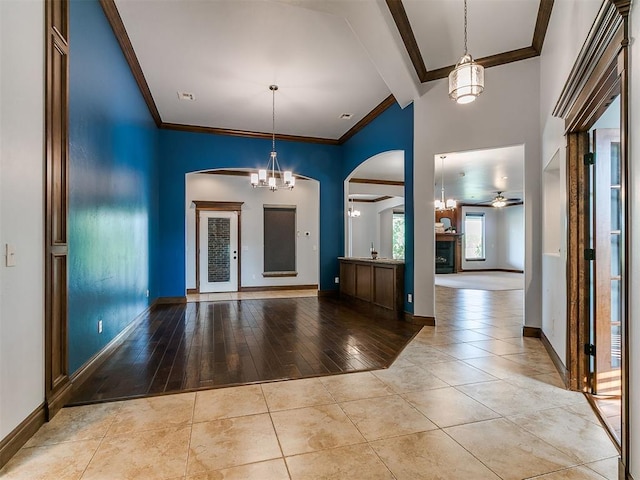 13705 Cascata Strada St, Oklahoma City, OK 73170 - entryway with arched walkways, a ceiling fan, a high ceiling, crown molding, and beam ceiling