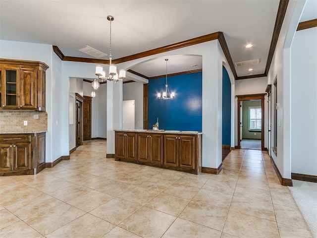 13705 Cascata Strada St, Oklahoma City, OK 73170 - kitchen featuring a chandelier, ornamental molding, light tile patterned flooring, light stone countertops, and decorative backsplash