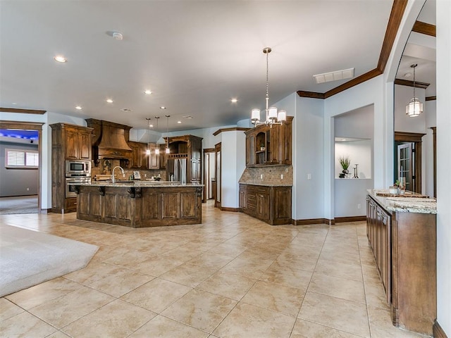 13705 Cascata Strada St, Oklahoma City, OK 73170 - kitchen featuring appliances with stainless steel finishes, premium range hood, tasteful backsplash, a large island, and a breakfast bar