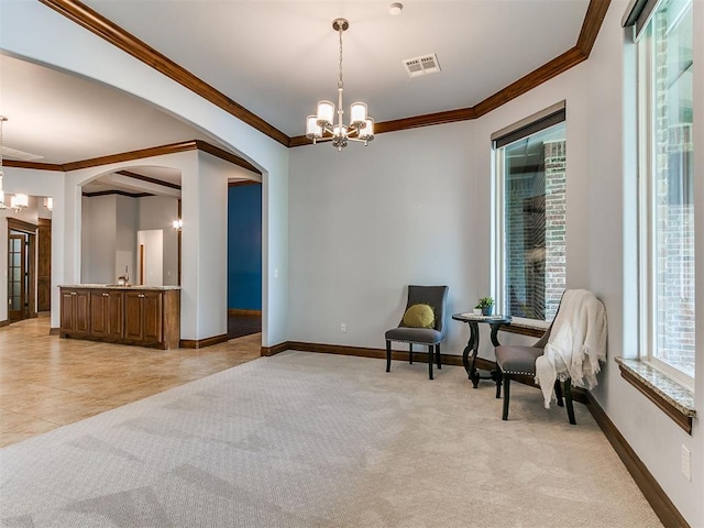 13705 Cascata Strada St, Oklahoma City, OK 73170 - living area with a chandelier, arched walkways, crown molding, and light colored carpet