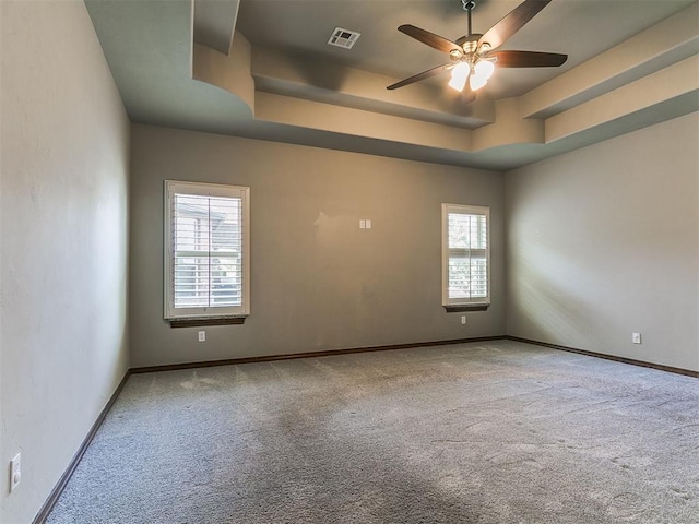 13705 Cascata Strada St, Oklahoma City, OK 73170 - empty room featuring carpet floors, healthy amount of natural light, a raised ceiling, and ceiling fan