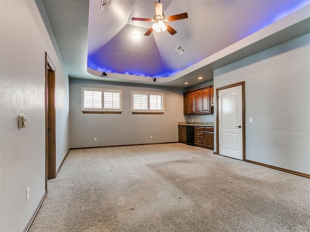 13705 Cascata Strada St, Oklahoma City, OK 73170 - unfurnished living room featuring a ceiling fan, light colored carpet, and a raised ceiling