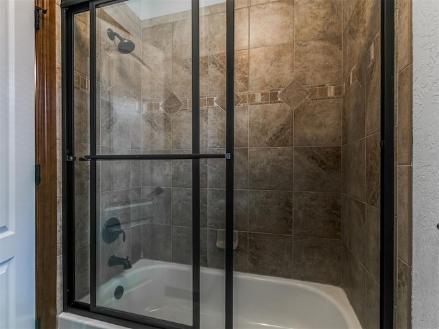13705 Cascata Strada St, Oklahoma City, OK 73170 - bathroom featuring bath / shower combo with glass door and a textured wall