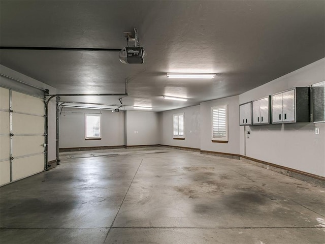 13705 Cascata Strada St, Oklahoma City, OK 73170 - garage with a garage door opener and baseboards