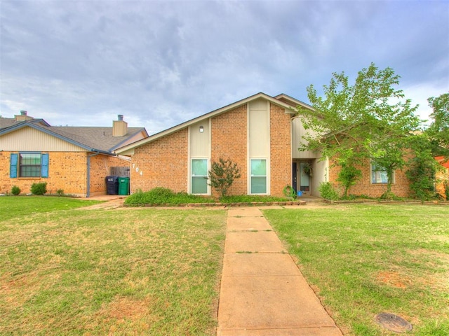 704 NW 137th St, Edmond, OK 73013 - view of front of home featuring brick siding and a front yard